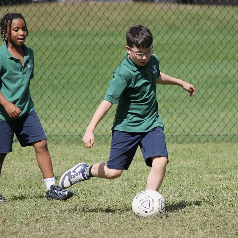 Gateway Christian Academy - Physical Education PE - elementary student kicking ball