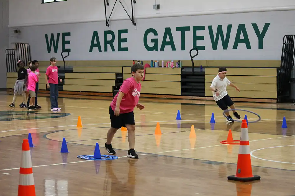 Gateway Christian Academy - Physical Education PE - kids running around cones